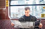 Man reading map in train