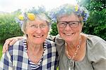 Senior women wearing flower wreaths