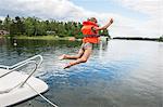 Girl jumping into water