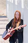 Young woman playing guitar