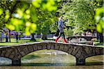 Stone, arch bridge crossing River Windrush, Bourton-on-the-Water, Gloucestershire, The Cotswolds, England, United Kingdom