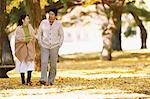 Senior Japanese couple in a city park in Autumn