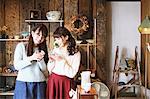 Young Japanese women enjoying visit to glass workshop in Kawagoe, Japan
