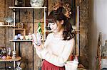 Young Japanese woman enjoying visit to glass workshop in Kawagoe, Japan