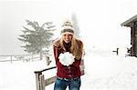 Young woman making a snowball