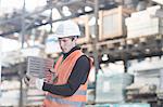 Young male warehouse worker steel product in warehouse