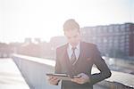 Young businessman using digital tablet on rooftop