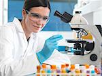 Scientist holding microscope slide with blood sample in lab