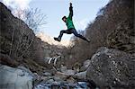 Man jumping over Toce River, Premosello, Verbania, Piedmonte, Italy