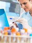 Medical researcher viewing data on a computer for a blood sample during testing