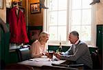 Couple drinking and chatting in pub