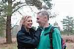 Romantic hiking couple walking in woods