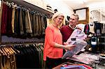 Couple browsing shirts in tailors shop