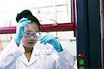 Female scientist pipetting sample in lab