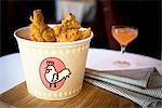 Bucket of fried chicken on restaurant table