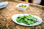 Plate with green chilli appetizer on restaurant table