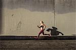 Female runner running on sidewalk