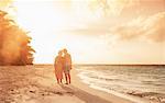 Senior couple on beach at sunset, Maldives
