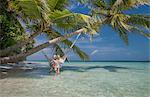 Senior couple relaxing in hammock, Maldives