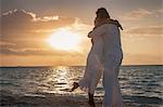 Senior couple hugging on beach, Maldives