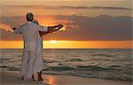 Senior couple on beach at sunset