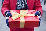 Midsection of man holding gift box winter