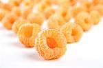 Close up of yellow raspberries on white background