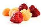 Red and yellow raspberries on white background