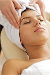 Young woman receiving energy therapy, eyes closed