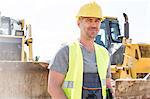 Portrait of confident supervisor standing at construction site