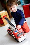 Little boy playing with a fire truck