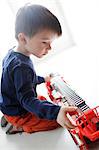 Little boy playing with a fire truck