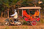 Camdodia, Siem Reap Province, Siem Reap Town, Angkor Temples, Site World Heritage of Humanity by Unesco in 1992, monks in a tuktuk