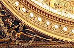 France,Paris. 9th district. Palais Garnier, Paris Opera. La Salle de Spectacle. Detail of gilding and sculptures at the base of the ceiling.