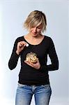 France, young woman in studio with gate currency.