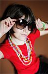 Little girl with sunglasses and necklaces