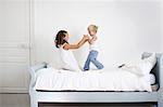 Brother and sister plying on a bed