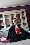 Little girl wearing a black robe as a judge