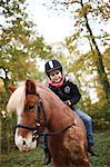 Little girl riding a pony