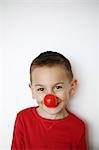 Little boy wearing clown nose