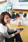 Family using different electronic devices in their living room