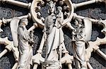 Notre Dame de Paris cathedral. Western facade. In front of the Rose window. Crowned Virgin and child surrounded by two angels. France.