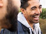 Close up of two smiling young men.