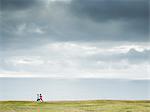 Two women jogging along the coast.