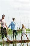 Family holding hands on dock, portrait