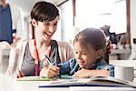 Mother and young daughter reading together