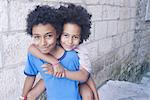 Young siblings embracing outdoors, portrait