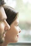 Woman gazing out window, profile