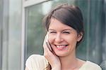 Woman using cell phone, smiling cheerfully