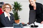 Cheerful two business women working at the office